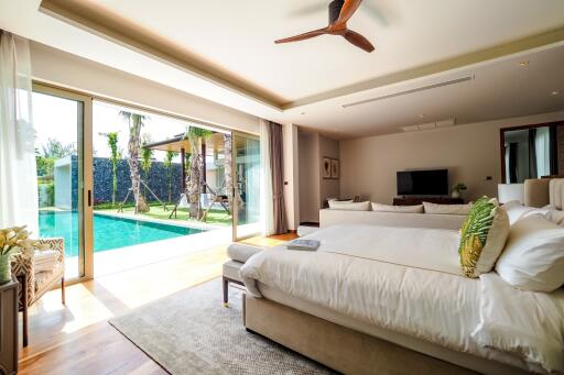 Spacious bedroom with a pool view and modern furnishings