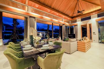 Spacious living area with dining table and couch under wooden ceiling