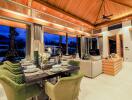 Spacious living area with dining table and couch under wooden ceiling