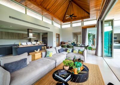 Modern living room with open kitchen and pool view