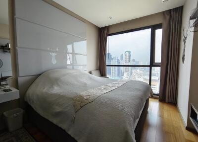 Modern bedroom with large window and city view