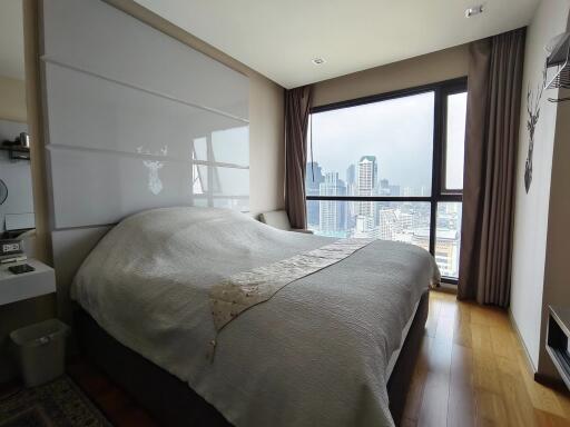 Modern bedroom with large window and city view