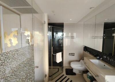 Modern bathroom with glass shower and mosaic tile accents