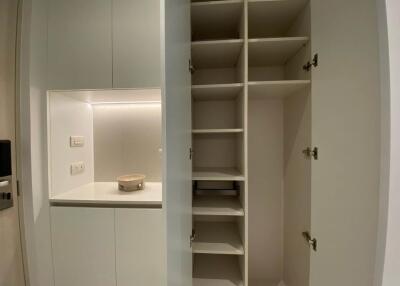 Built-in storage unit with shelves and small counter space