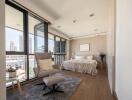 Modern bedroom with large windows and a comfortable chair