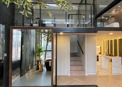 Modern mezzanine living area with indoor plants and stylish furnishings