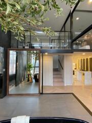 Modern mezzanine living area with indoor plants and stylish furnishings