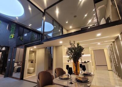 Modern, well-lit interior with mezzanine, dining area, and stylish decor