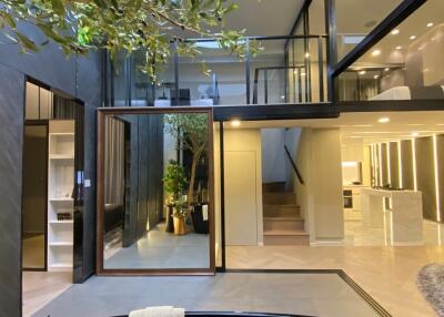 Modern loft-style living area with open floor plan and black bathtub