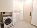 Laundry room with washing machine and storage cabinets