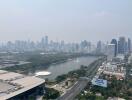 View of the city showing a park with a lake and tall buildings in the background