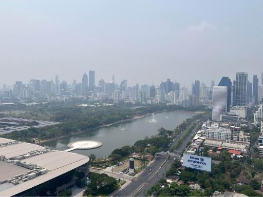 View of the city showing a park with a lake and tall buildings in the background