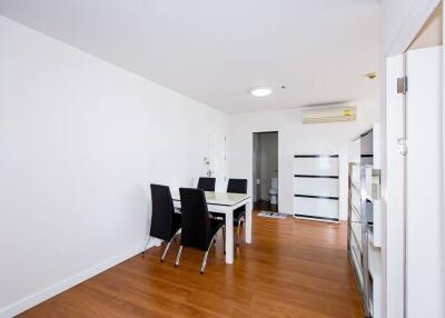 Minimalist dining room with white walls and hardwood floor