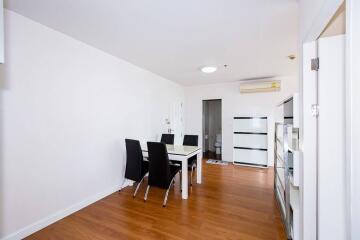 Minimalist dining room with white walls and hardwood floor