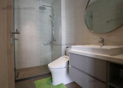 Modern bathroom with glass shower and white sink