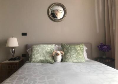 Cozy bedroom with decorative pillows and a plush toy