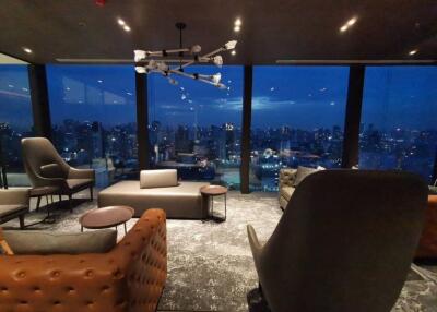 Modern living room with panoramic city view at night