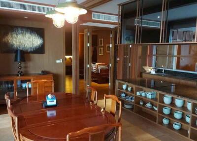 Dining area with wooden table and built-in cupboards