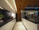 Modern kitchen with sleek white cabinets, black countertops, and integrated lighting