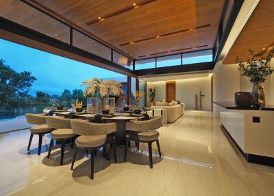 Modern open-concept living and dining area with large windows