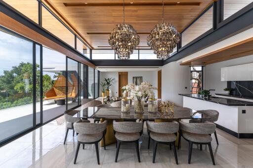 Spacious dining area with large glass windows and modern chandeliers