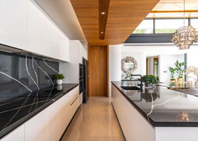 Modern kitchen with marble countertops and wooden accents