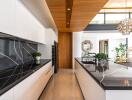 Modern kitchen with marble countertops and wooden accents