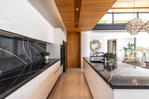 Modern kitchen with marble countertops and wooden accents