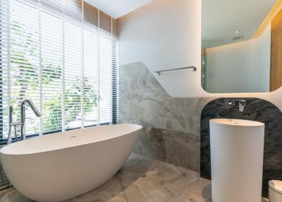 modern bathroom with bathtub and large window