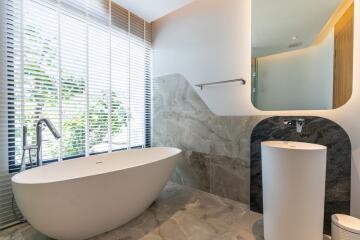 modern bathroom with bathtub and large window