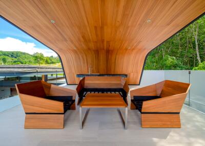 Modern balcony with wooden ceiling and furniture