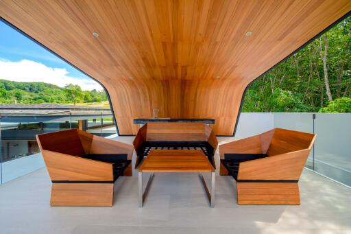 Modern balcony with wooden ceiling and furniture