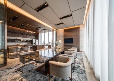 Luxurious modern dining room with a marble table and upholstered chairs.