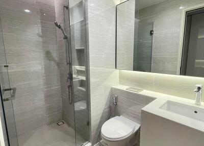 Modern bathroom with glass shower and wall-mounted toilet