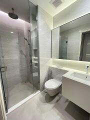 Modern bathroom with glass shower and wall-mounted toilet