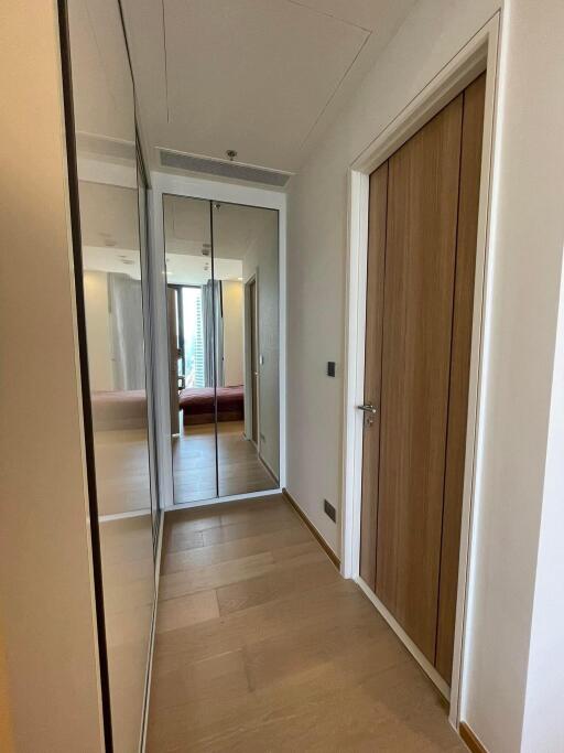 Hallway with mirrored wardrobe and wooden door