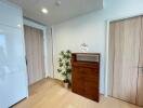 Spacious hallway with wooden cabinets and light wood flooring