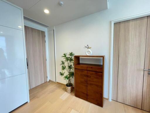 Spacious hallway with wooden cabinets and light wood flooring