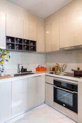 Modern kitchen with white cabinets and integrated appliances