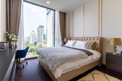 Modern bedroom with large window and city view