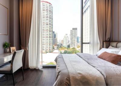 Modern bedroom with large window and city view