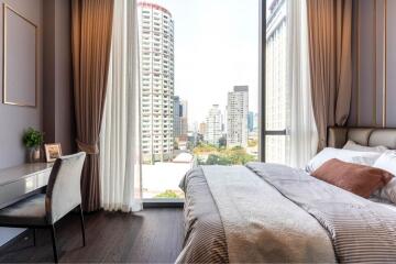 Modern bedroom with large window and city view