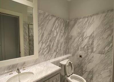 Modern bathroom with marble decor and white fixtures