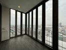 Modern balcony with floor-to-ceiling windows and city view