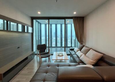 Modern living room with large windows and city view