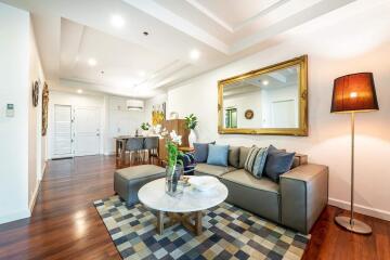 Modern living room with wooden flooring, comfortable seating, and stylish decor