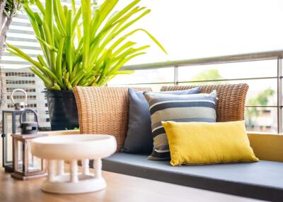 Cozy balcony seating area with cushions and plants