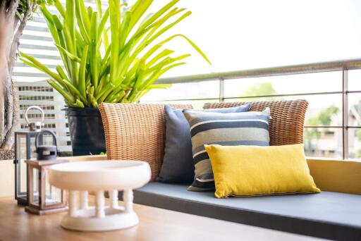 Cozy balcony seating area with cushions and plants