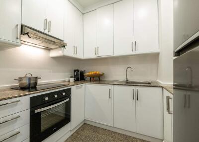 Modern kitchen with white cabinets and granite countertops