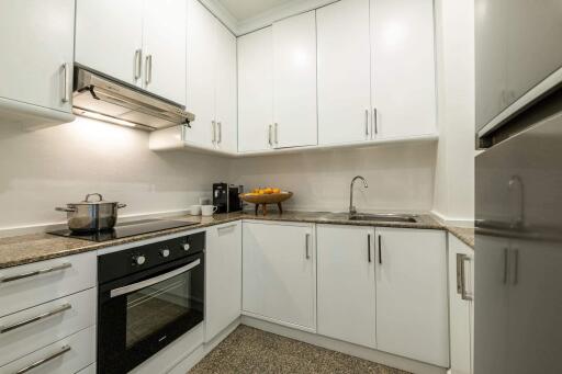 Modern kitchen with white cabinets and granite countertops